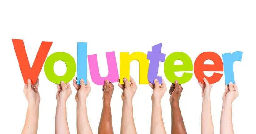 Diverse Hands Holding The Word Volunteer